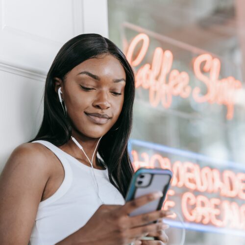 Woman Smiling and Looking at Cellphone