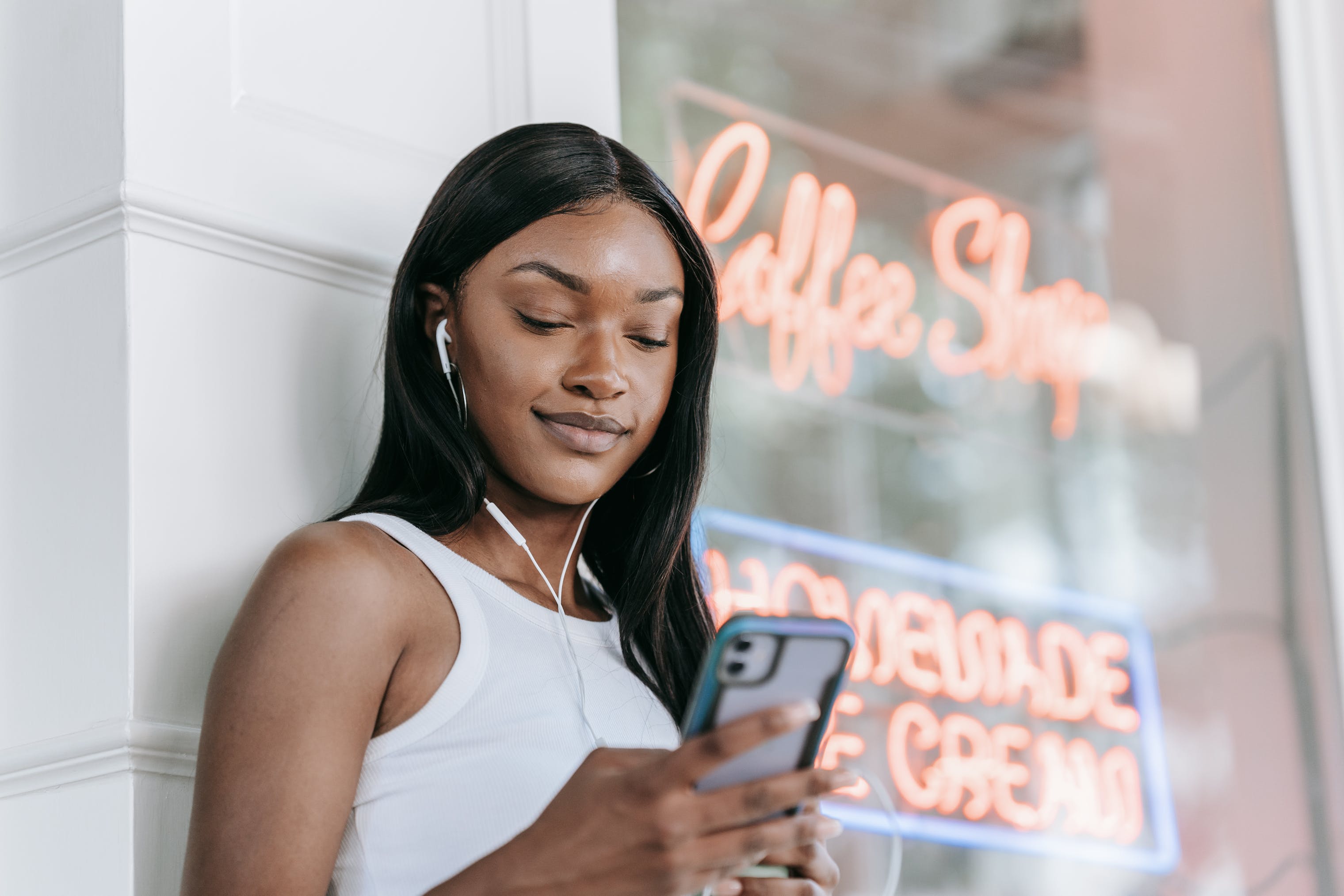 Woman Smiling and Looking at Cellphone